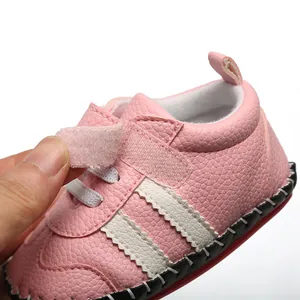 Gros plan détaillé d'une chaussure de bébé rose avec semelle en caoutchouc et velcro