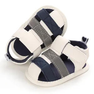 Close-up of soft-soled baby sandals with blue and grey striped design