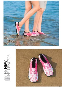Détail des chaussures aquatiques à séchage rapide avec motif rose sur la plage