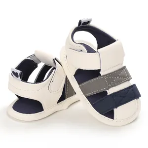 Detail view of baby summer sandals with soft soles and velcro straps in white and navy