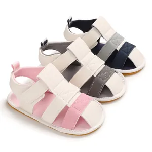 Close-up of soft-sole baby sandals in pink, grey, and navy blue for 0-1 year olds