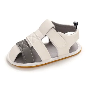 Detailed view of white and gray baby sandals with soft soles for 0-1 year olds