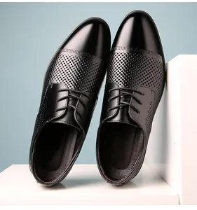 Dettaglio scarpe stringate da uomo in pelle nera con motivo traforato traspirante