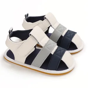 Side view of color-blocked infant sandals with soft soles and velcro straps