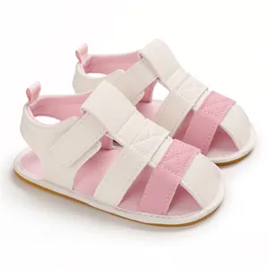 Detailed view of pink and white infant summer sandals featuring soft non-slip soles