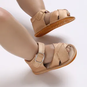 Side view detail of champagne gold baby sandals with soft rubber sole and metal buckle