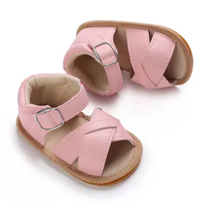 Detailed view of pink baby girl sandals with soft rubber soles for infant walkers.