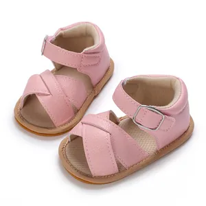 Detail view of pink baby girl walking shoes with soft rubber soles and cross straps