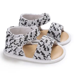 Detail shot of breathable houndstooth baby sandals with soft soles and buckle straps