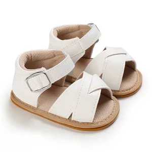 Macro detail of white faux leather baby walking shoes featuring soft non-slip soles