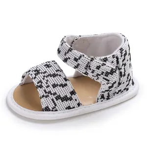 Detail of black and white houndstooth patterned soft sole baby sandals for early walkers