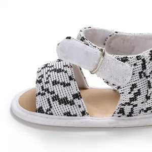 Detail of breathable baby walker shoe with checkered fabric and secure velcro strap