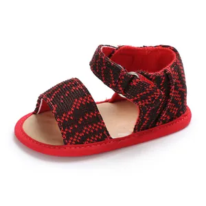 Close-up of a breathable baby walking shoe with a soft red and black knit upper.