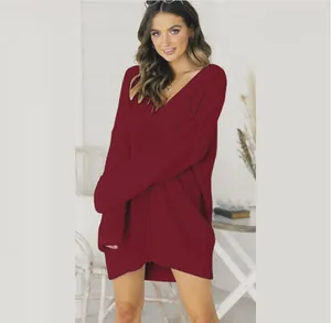 Detail view of the deep burgundy V-neck knitted sweater dress showing fabric texture