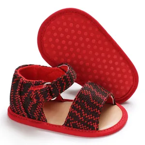 Detailed view of red and black woven infant walking shoes featuring an anti-slip soft sole design