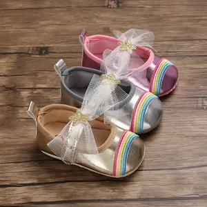 Metallic baby girl walking shoes in pink, silver and gold featuring a rainbow design.