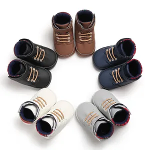 Overhead view of multi-colored infant high-top soft sole walking shoes in a circular layout