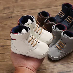 Close-up detail of high-top baby walking shoes with soft soles and velcro straps.