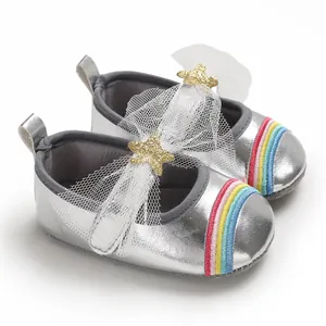 Detailed view of silver baby girl walking shoes with rainbow stripe and gold star bow