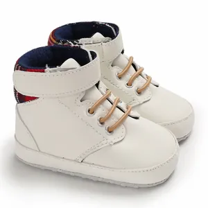 Detail of cream high-top baby walking shoes with soft soles and plaid collar lining