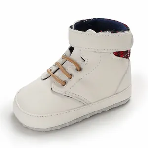 White high-top baby walking shoe with soft sole and stylish red plaid lining detail