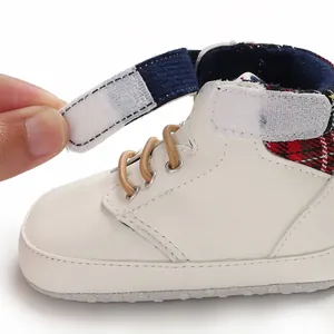 Detail of baby walking shoe showing the adjustable hook and loop strap
