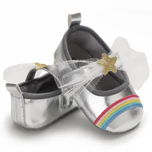 Detailed shot of silver baby princess shoes with white mesh bow and rainbow accent