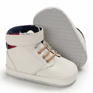 Detail showing soft anti-slip sole and white faux leather finish of baby shoes