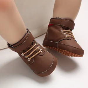 Close-up of brown high-top baby walking shoes with soft dotted soles