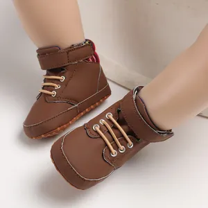 Detail shot of brown baby high-top walking shoes with soft soles and velcro strap