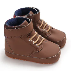 Detailed view of brown high-top baby walking shoes with soft soles and plaid lining