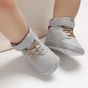 Close-up detail of grey high-top baby walking shoes featuring soft soles and velcro straps