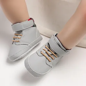 Close-up of grey high-top soft sole baby walking shoes with velcro strap and plaid detail