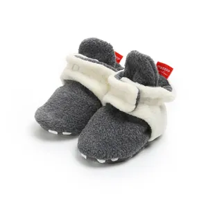 Soft fleece baby booties in grey and white with warm plush lining for winter