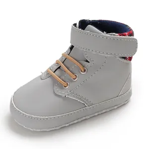 Detail view of grey high-top baby walking shoe with soft sole and plaid lining