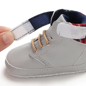 Close-up of gray baby walking shoe with adjustable hook-and-loop strap and soft sole