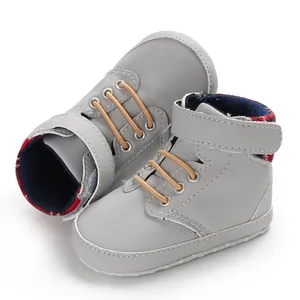 Close-up view of grey high-top baby pre-walker shoes featuring soft soles and velcro straps.