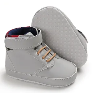 Macro view of grey high-top baby walking shoes featuring non-slip dotted soft soles