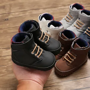 Detailed view of high-top baby walking shoes with soft soles in various colors on wood
