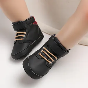 Detail view of black high-top baby walker shoes with soft sole and velcro strap