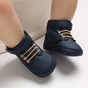 Close-up of navy blue baby high-top walking shoes with soft soles and velcro straps