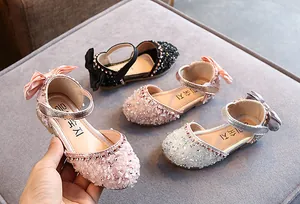 Detail van fonkelende strass prinsessenschoenen voor meisjes met een mooie strik.