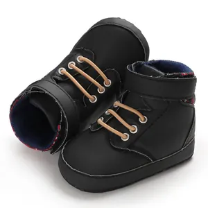 Detailed close-up view of black high-top baby walking shoes with soft soles and plaid lining