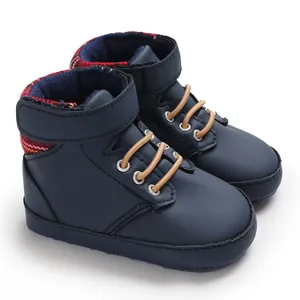 Close-up detail of navy blue high-top baby walking shoes with soft sole and plaid lining