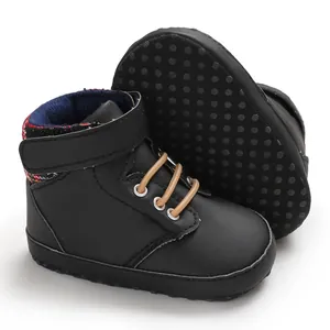 Detailed view of black high-top baby walking shoes with soft anti-slip rubber dot sole