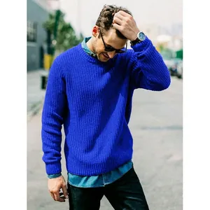 Close-up of a men's slim fit cobalt blue ribbed knit sweater worn in a street style setting