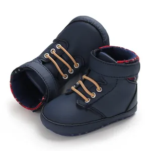 Detailed close-up of navy blue high-top baby walking shoes with soft soles and elastic laces