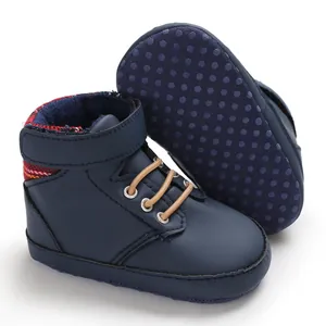 Detail view of navy blue high-top baby walking shoes with purple non-slip dotted sole
