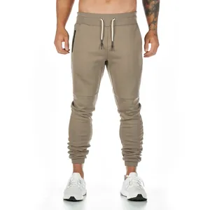 Close-up front view of men's slim-fit joggers in olive green with drawstring waist
