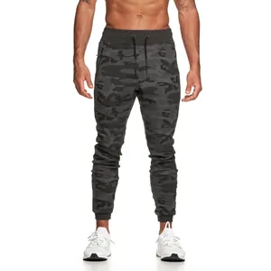 Detailed view of dark grey camouflage joggers with functional drawstring and zip pocket